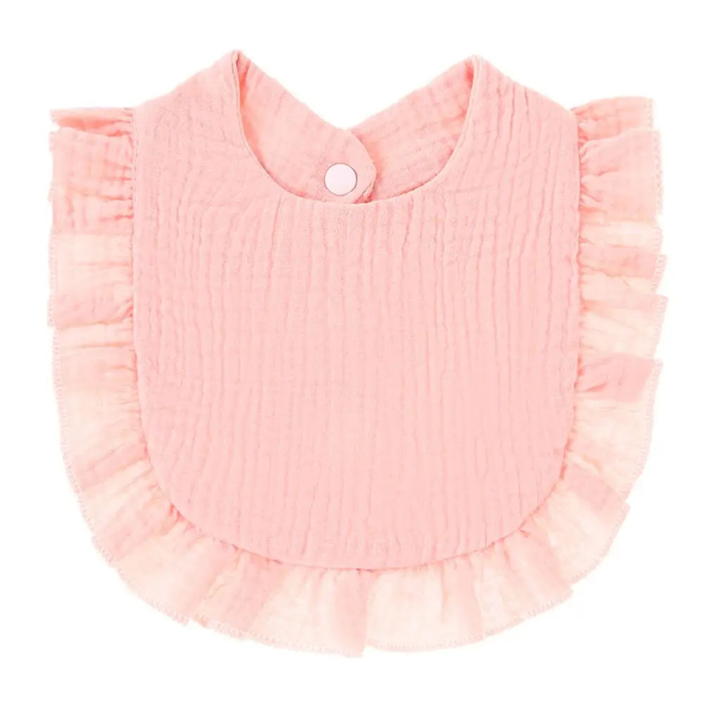 A light pink, ribbed cotton baby bib in a bandana style with ruffled edges.