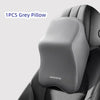 A single grey memory foam pillow is shown placed on a car headrest or lumbar support cushion.