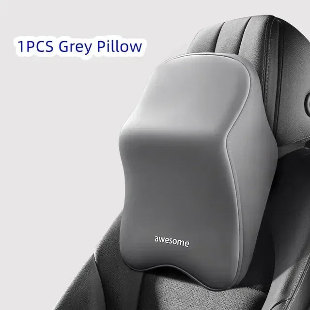 A single grey memory foam pillow is shown placed on a car headrest or lumbar support cushion.