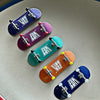 A collection of seven wooden fingerboard skateboards in various colors and finishes.