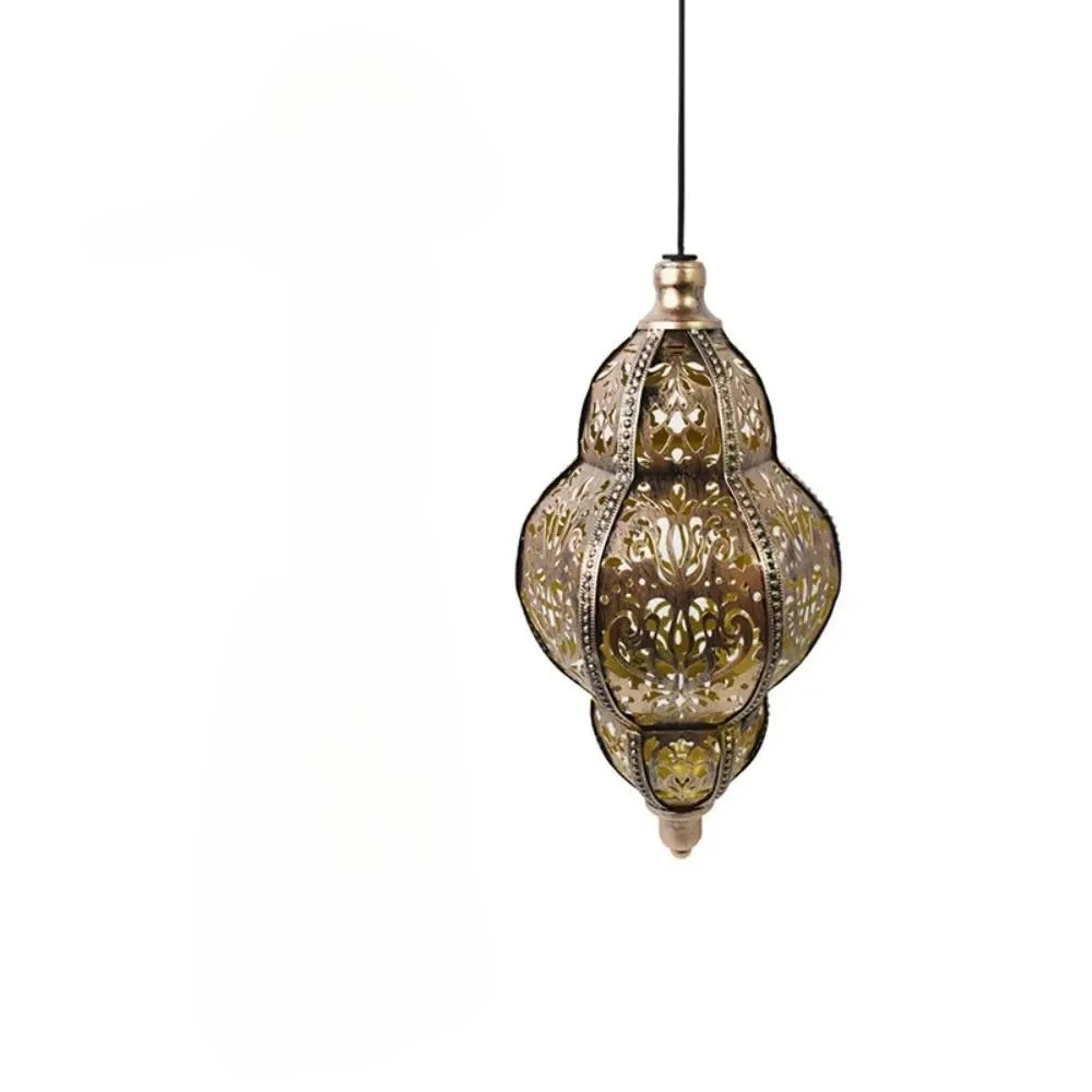 A vintage brass solar hollow-out lantern with decorative etching, suspended by a black cord.