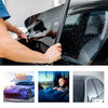 A hand is applying ceramic tint film to a car window, demonstrating heat and UV protection.