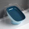 A blue suction cup soap holder with a drainage tray shown in profile view.