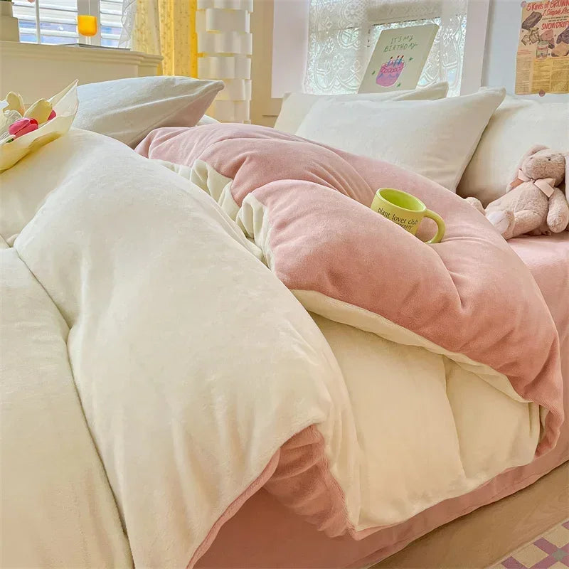 A close-up of a cozy milk velvet bedding set featuring a pink duvet cover and white pillows.