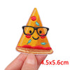 An embroidery patch shaped like a smiling cartoon cat wearing black glasses and sitting on a slice of pizza.