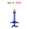 A clear glass syringe injector with a gold tip and blue plunger for air conditioning oil and dye.