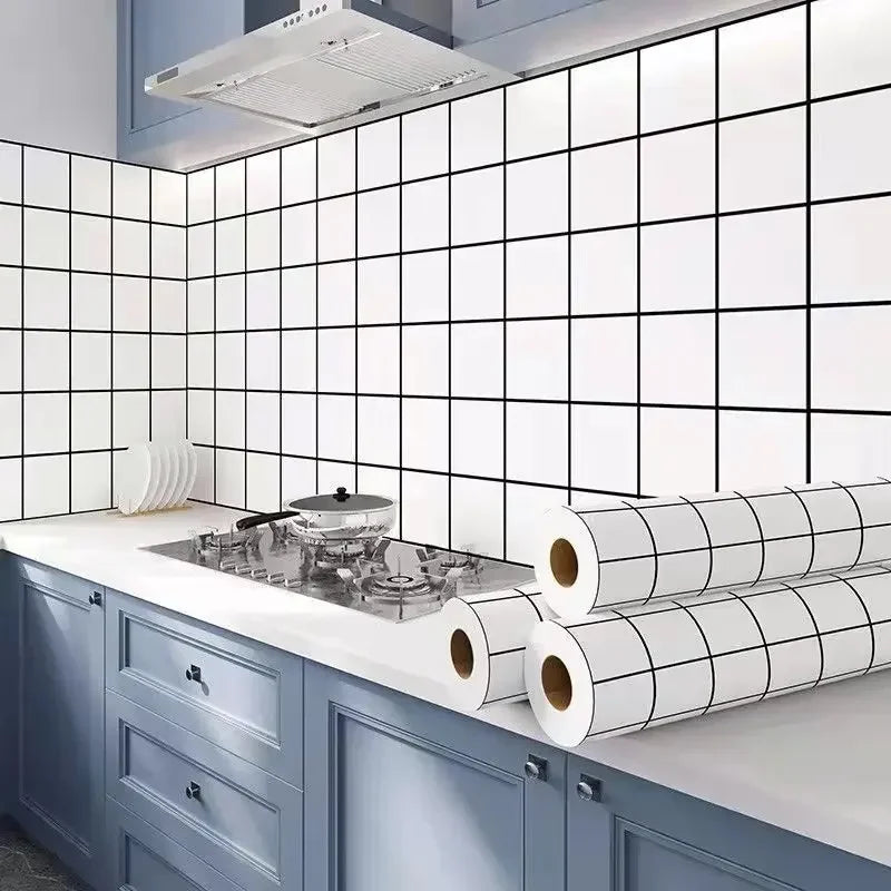 A kitchen splashback featuring white square tiles and blue cabinetry with rolled self-adhesive stickers.