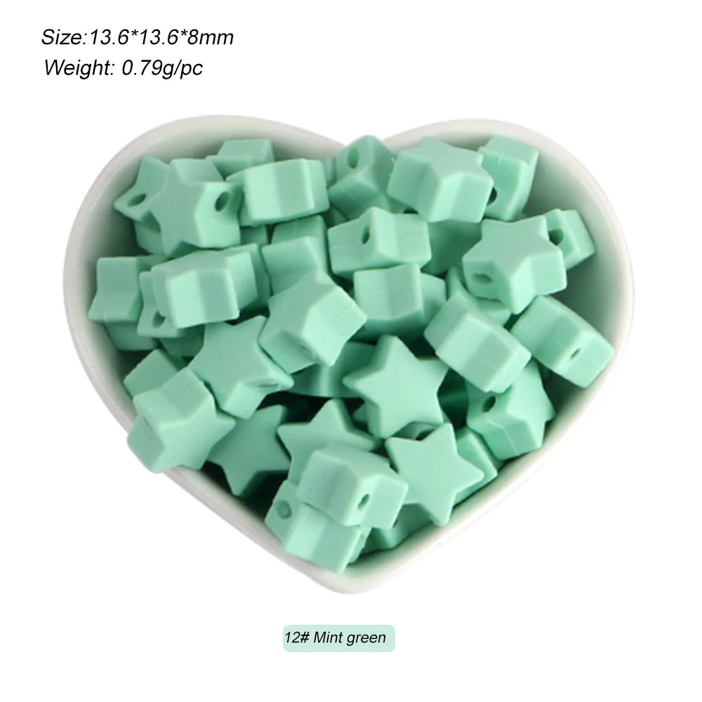 A pile of mint green silicone crown star heart beads for DIY jewelry making