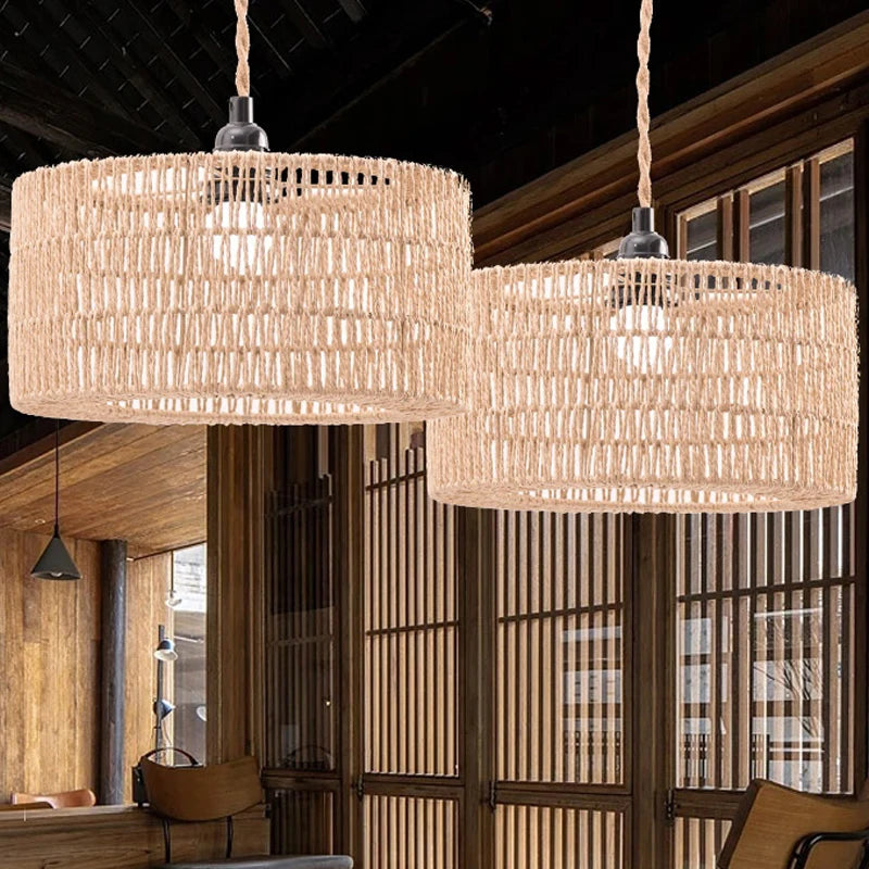 Two large woven paper rope pendant lampshades hang in a wooden interior setting.