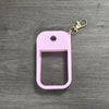 A pink silicone protective case for a hand sanitizer spray attached to a metal keyring.