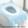 A light blue disposable toilet seat cover with a white rim is shown on a toilet.