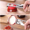 A hand is using an adjustable stainless steel can opener to open a glass jar of preserves.