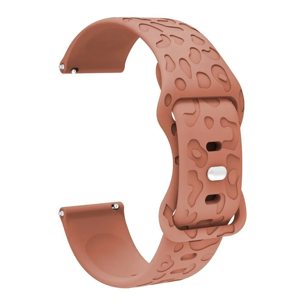 A close-up view of a rose gold silicone watch band with an engraved pattern for a Redmi Watch 5.