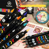 A close-up of a set of black dual-tip acrylic paint markers with various colored tips arranged for art and craft.