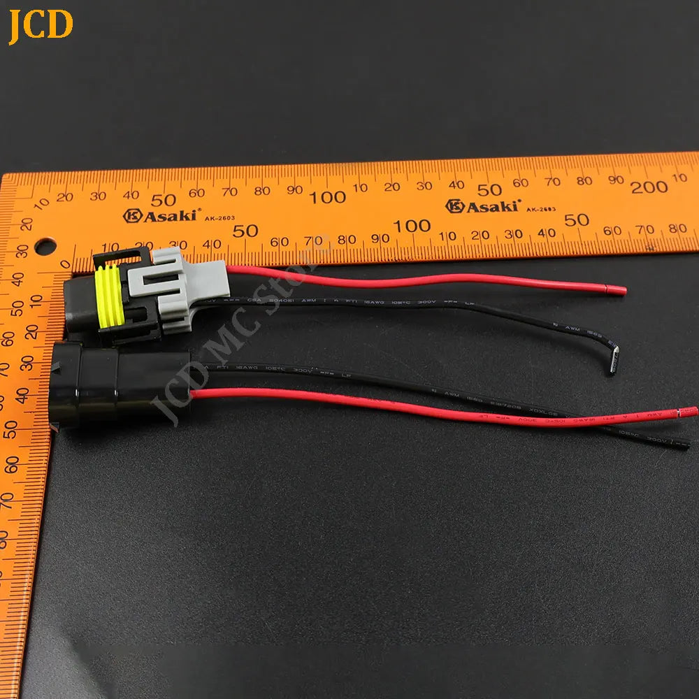 Wiring harness for an H8/H11 headlight adapter with a 15cm cable shown next to a ruler.