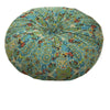 A round floor cushion covered in a blue and green bohemian cotton linen fabric with intricate patterns.