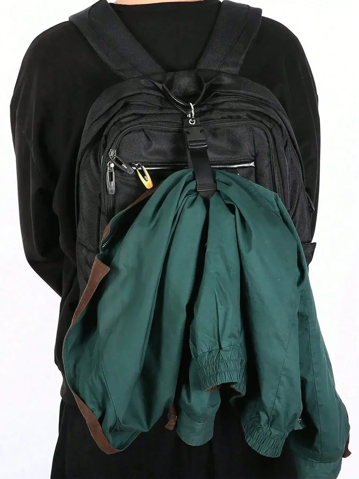 A dark green durable polyester luggage strap with an ID tag is draped over a black backpack.
