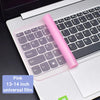 A pink universal film keyboard cover is placed on a white laptop keyboard.