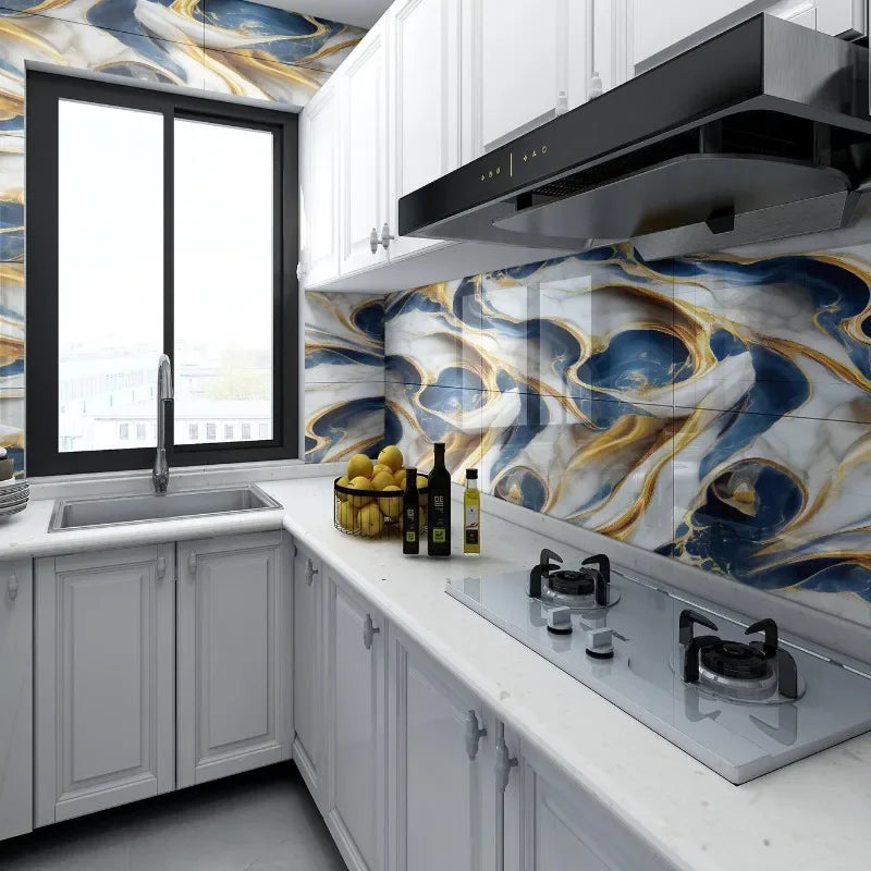 Modern kitchen featuring white cabinetry, marble countertops, and blue and gold marbled wall tiles.