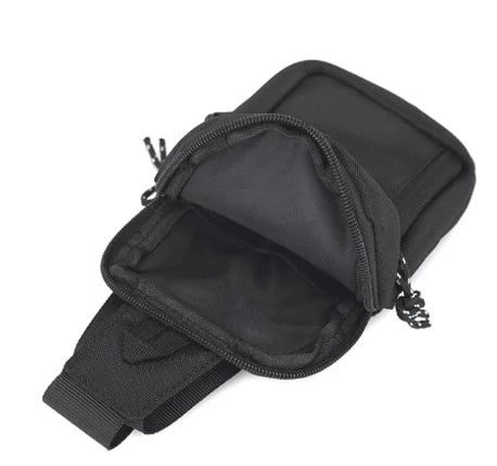 Black compact canvas crossbody bag with a zippered compartment and strap.