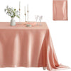 A pink satin tablecloth set for dining or events, featuring a square cover and elegant place settings.