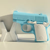 A light blue mini 3D printed gravity fidget pistol toy resting on a white surface.