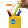 A yellow container holds various colored pens and a magnetic staple remover pen with an ergonomic grip.