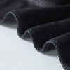 A close-up of a folded black microfiber bath towel showing its texture and soft drape.