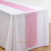 Elegant satin pink table runner draped across a white tablecloth.