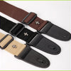 A set of vintage cross pattern guitar straps in brown, black, and tan leather with pick pockets.