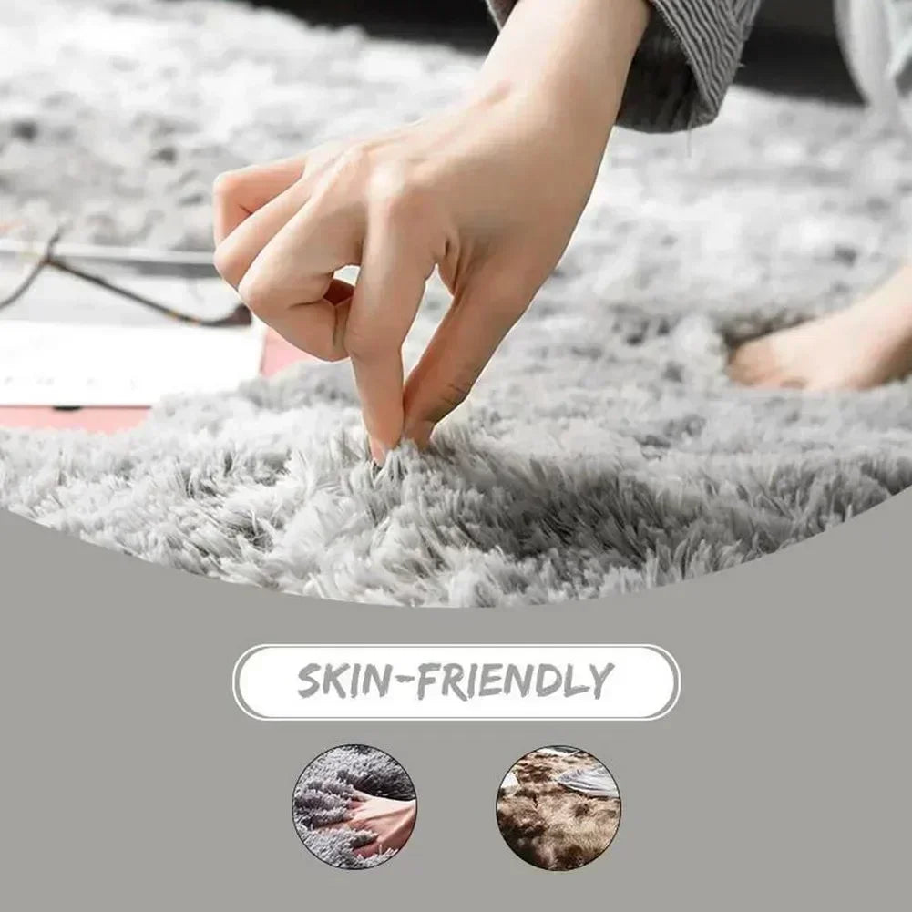 A hand is touching a fluffy gray shaggy area rug, highlighting its skin-friendly quality.