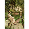 A painting depicting a woman in period dress sitting on a wooden step in a lush garden setting.
