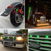 Close-up of a black LED side marker light mounted on a truck wheel, next to a Ford truck and a green light bar on a trailer.