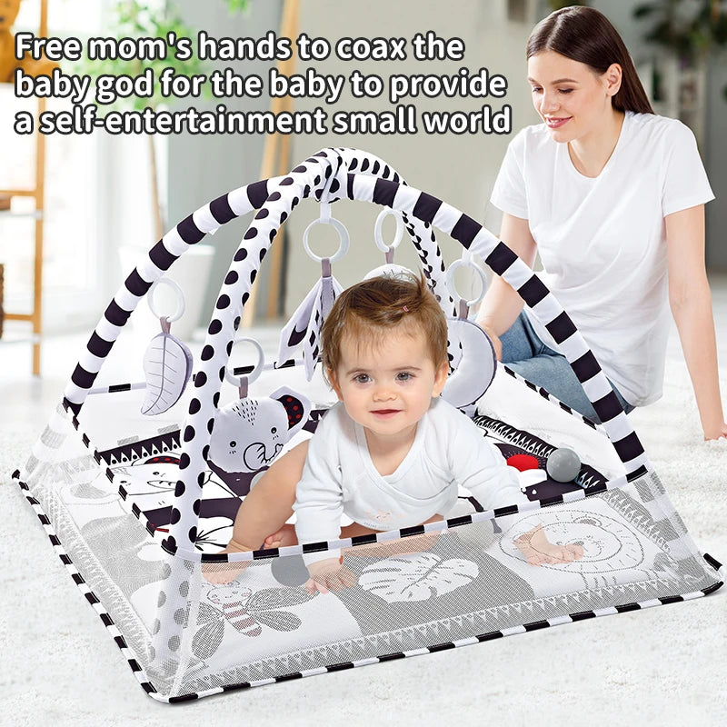 A mother is shown using a baby play gym and activity mat with hanging toys for a baby.