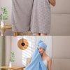 A woman is shown draping a light blue plush coral velvet bath towel on her body in a bright, modern setting.