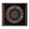 A dark woven throw blanket featuring a central sunburst design with radiating panels and fringed edges.