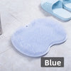 A blue suction cup foot massage mat with exfoliating bristles is shown on a white surface.