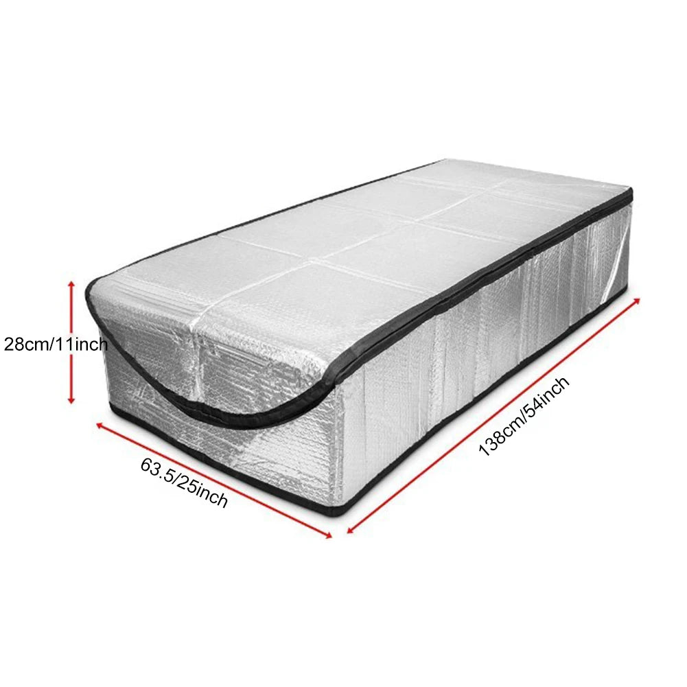 A rectangular attic stairway insulation cover made of silver foil material with black trim.