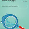 A blue magnifying glass toy is shown against a light green background, illustrating a product for baby's delicate skin.