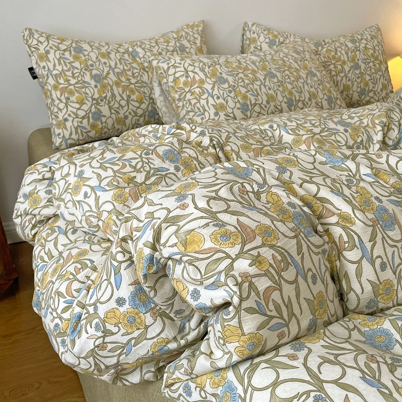 A beige and yellow floral printed duvet cover set with matching pillowcases on a bed.