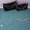 Black leather purse with multiple silver chain straps and pendant charms