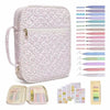 A floral quilted Bible cover with a zipper pocket and carry handle shown alongside various colored pens and pencils.