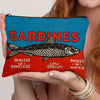 A teal cosmetic bag with a black and red sardine print featuring the text Sardines Skinless Boneless Low Sodium Packed In Wat