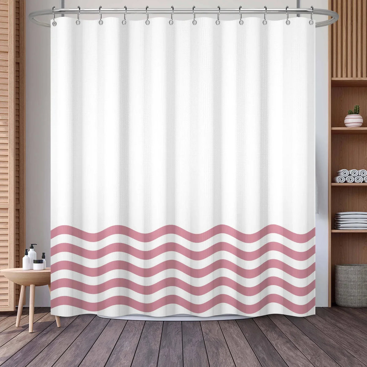 White shower curtain featuring a wavy pink and white stripe pattern hanging from a metal rod.