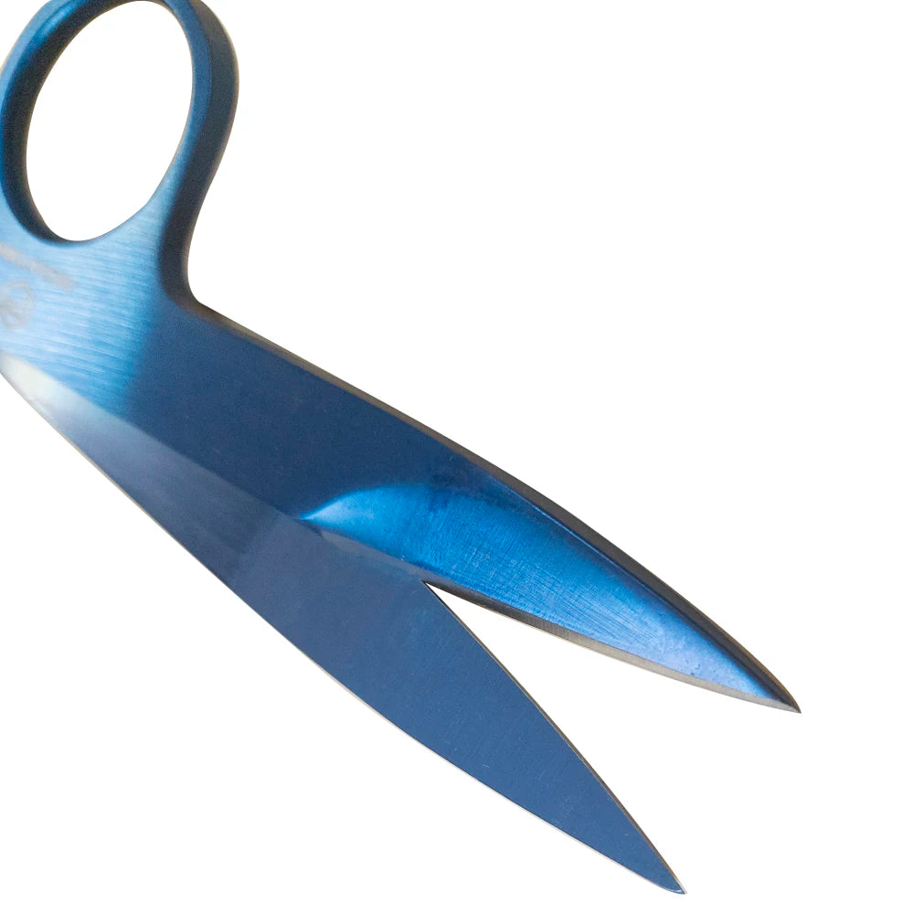 A close-up view of a blue precision titanium-coated tailor shears with a leather sheath.