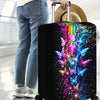 Black suitcase with an iridescent butterfly print featuring colorful wings and sparkling dust.