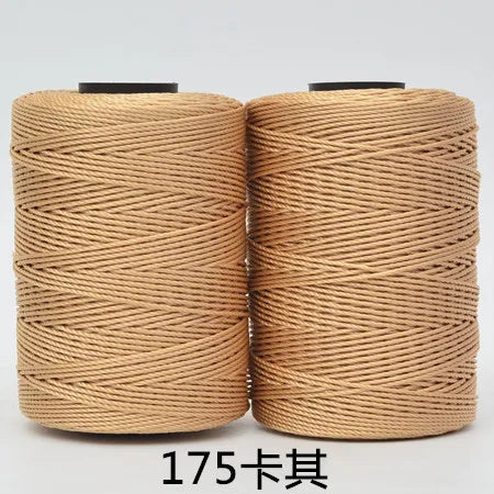 Spool of tan 3-ply polyester knitting yarn for crochet and hand crafts