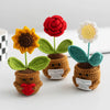 Handmade crochet plants with colorful flowers and leaves used as positive energy desk decor