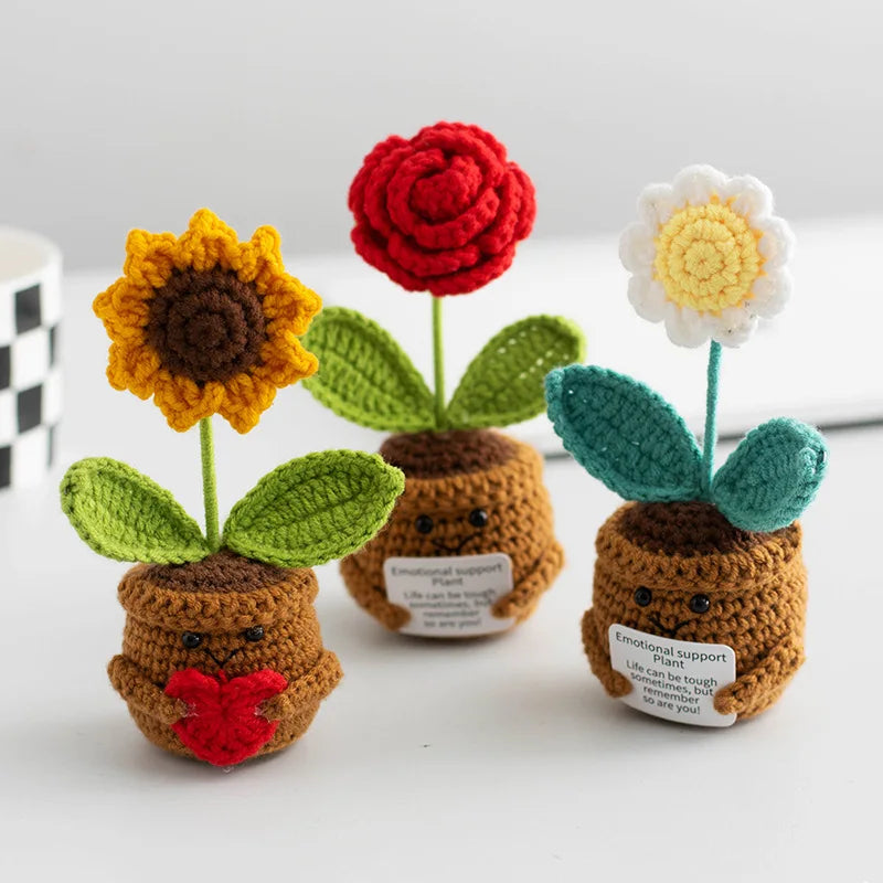 Handmade crochet plants with colorful flowers and leaves used as positive energy desk decor