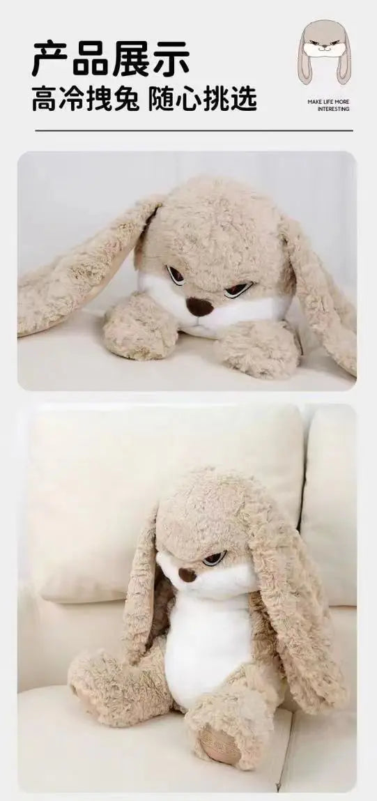 A light brown, long-eared angry rabbit plush toy is shown lying down on a white surface.